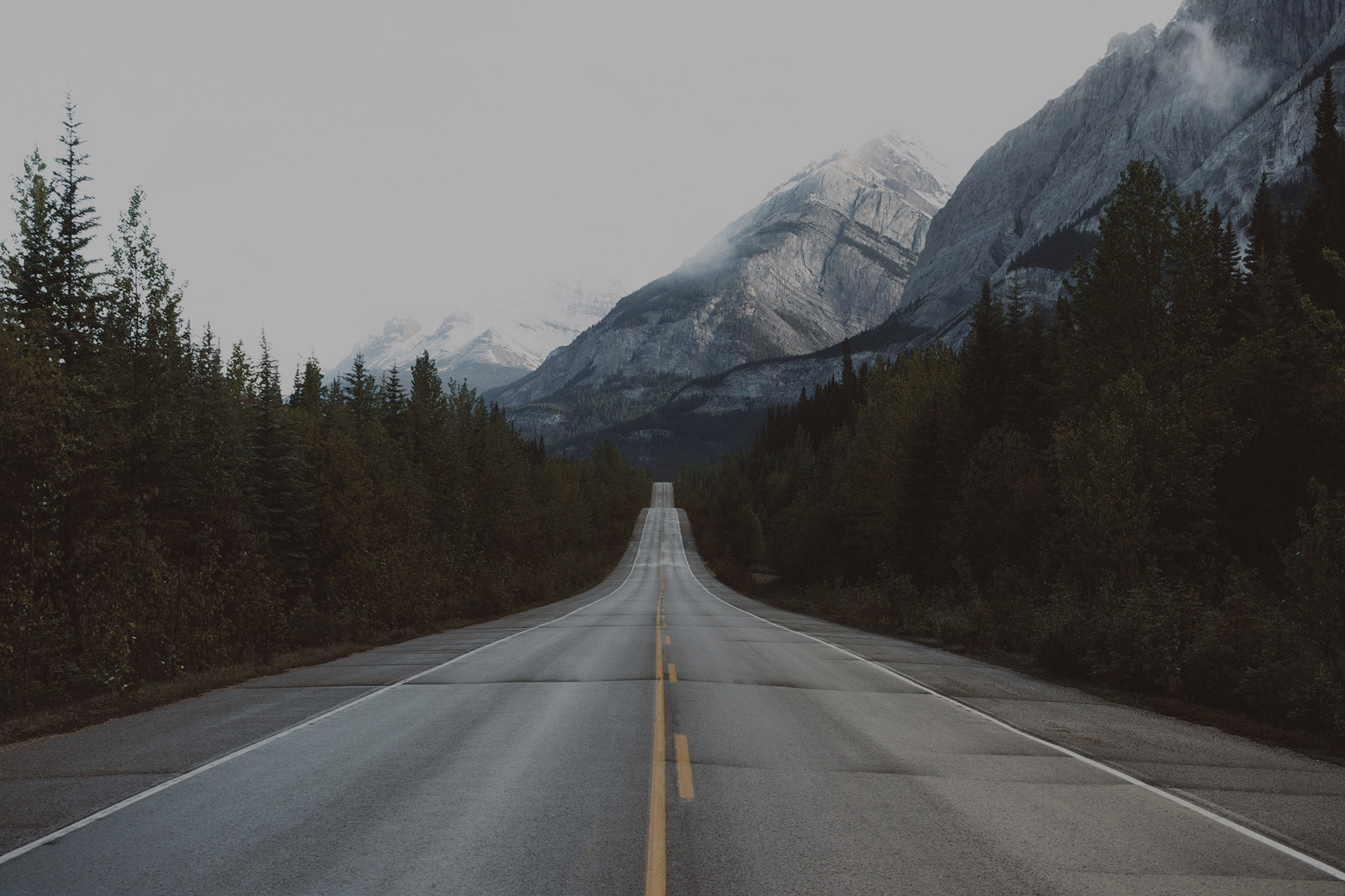A road leading toward the mountains